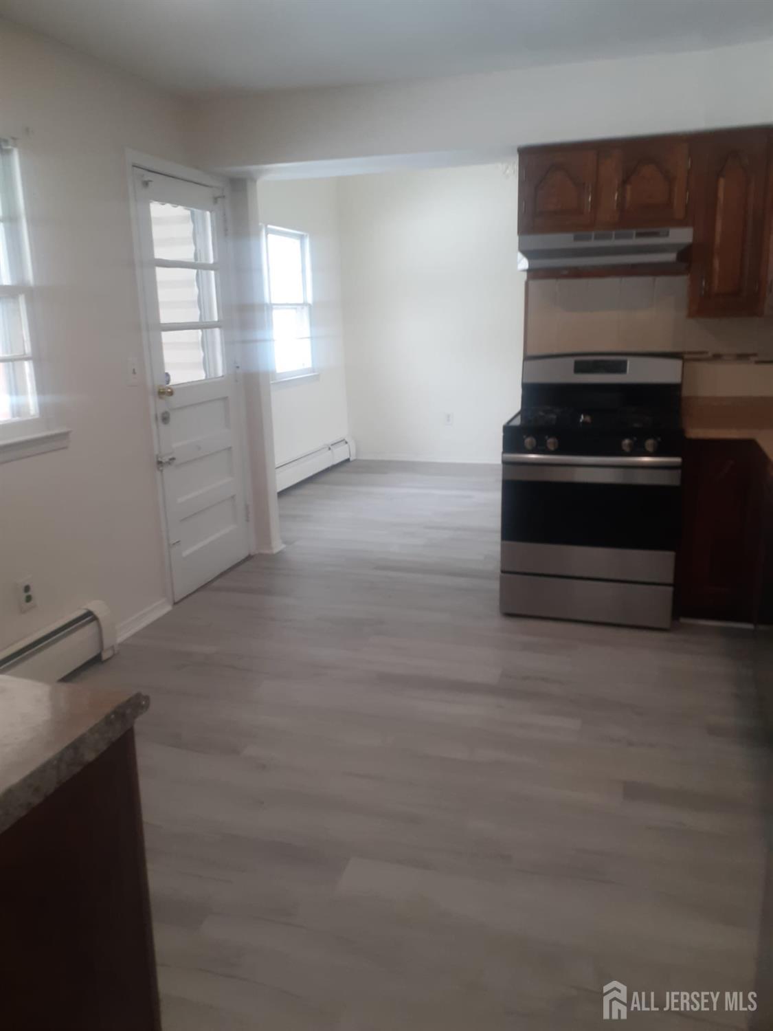 1776 Oak Tree Road Edison, NJ 08820 - Photo 5 of 9 a kitchen with granite countertop white cabinets and appliances