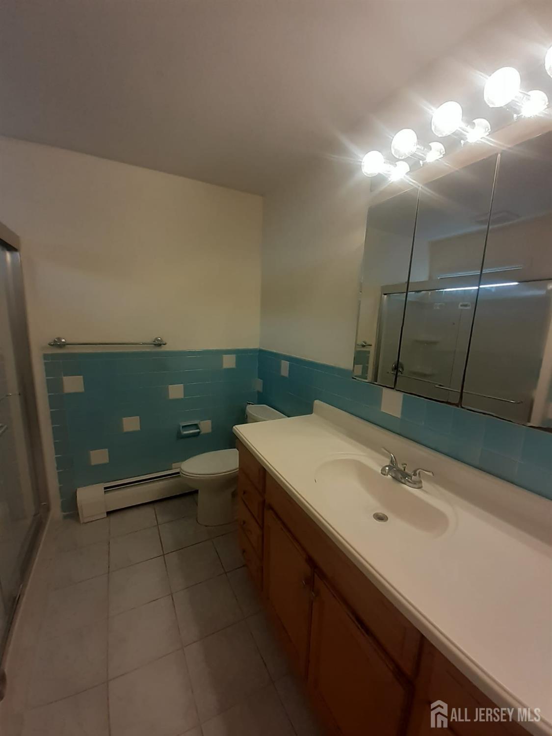 1776 Oak Tree Road Edison, NJ 08820 - Photo 7 of 9 a bathroom with a sink and mirror