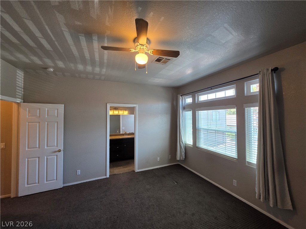 2275 Ramsgate Drive Henderson, NV 89074 - Photo 52 of 84 A comfortable bedroom with a ceiling fan and generous windows allowing abundant natural light.