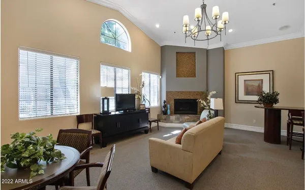 a living room with furniture chandelier and a fireplace