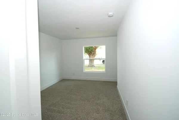 a view of an empty room and window