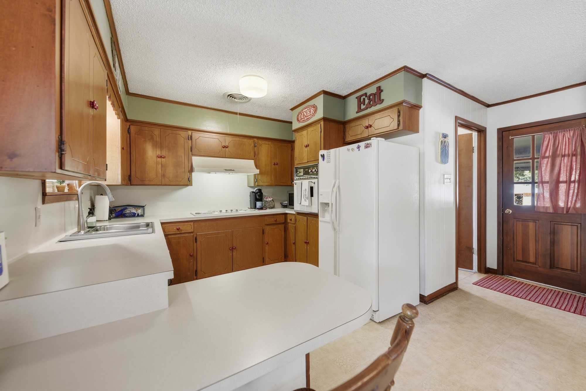 1705 Eldon Street Brenham, TX 77833 - Photo 14 of 30 a kitchen with refrigerator cabinets and a counter top space