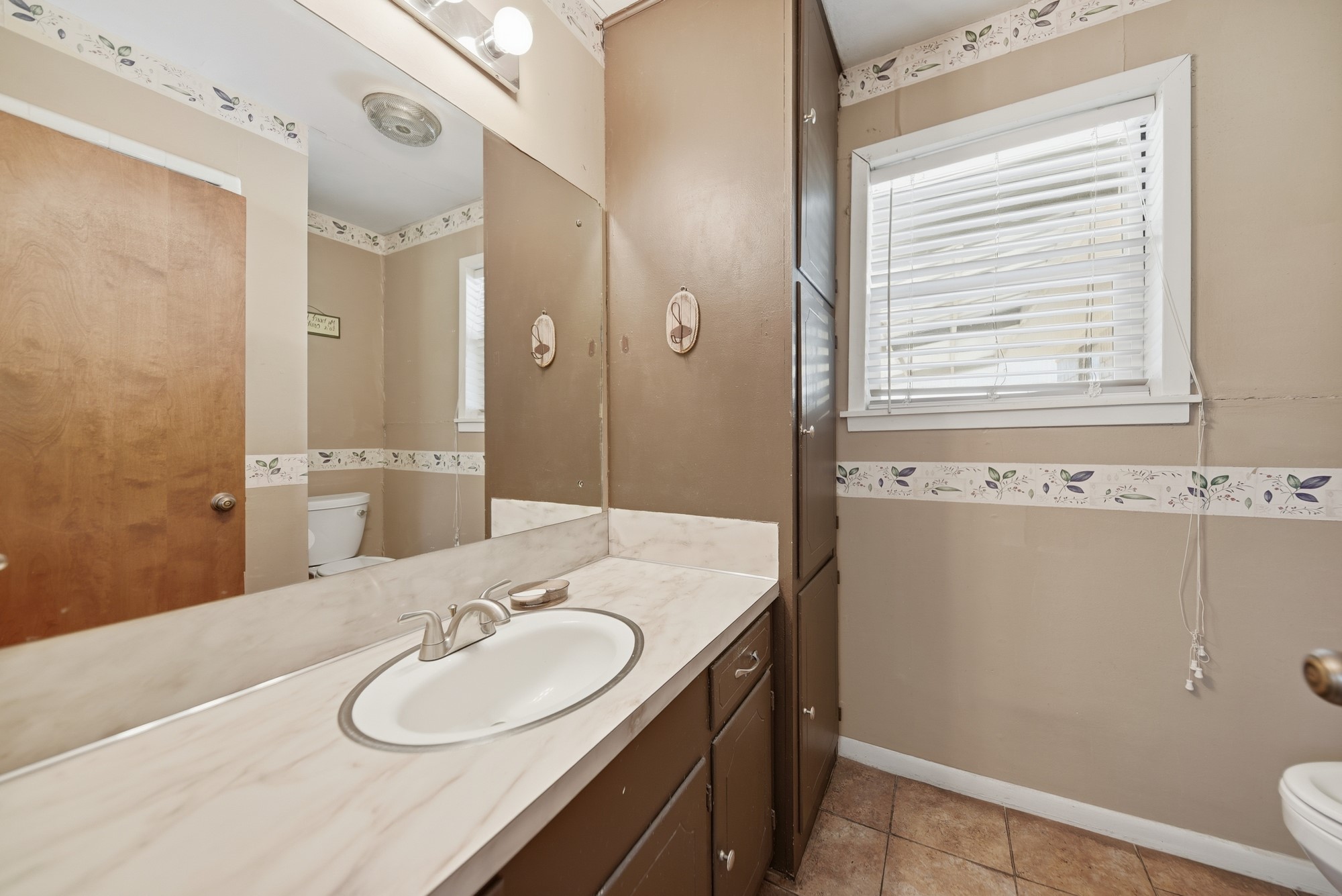 1705 Eldon Street Brenham, TX 77833 - Photo 19 of 30 a bathroom with a granite countertop sink and a mirror