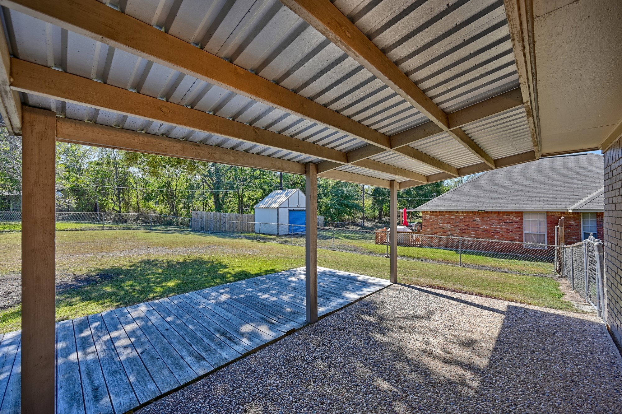 1705 Eldon Street Brenham, TX 77833 - Photo 26 of 30 a view of a backyard with table and chairs under an umbrella