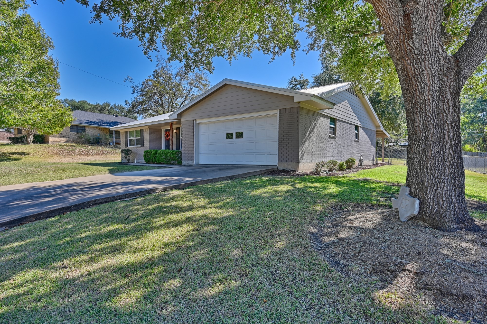 1705 Eldon Street Brenham, TX 77833 - Photo 6 of 30 a house with trees in the background