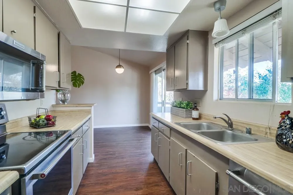 4768 35th Street, Unit 4 San Diego, CA 92116 - Photo 11 of 27 a kitchen with a sink stove and cabinets