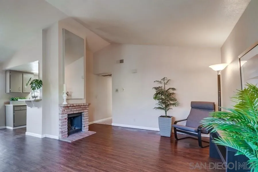 4768 35th Street, Unit 4 San Diego, CA 92116 - Photo 3 of 27 a living room with furniture a potted plant and a fireplace