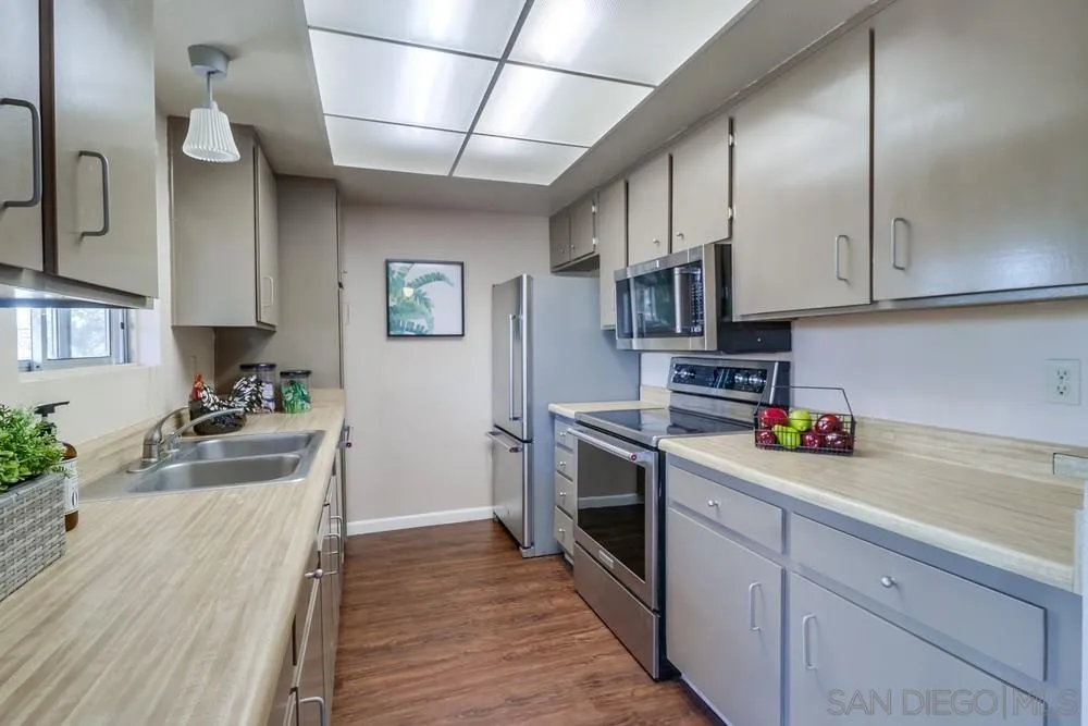 4768 35th Street, Unit 4 San Diego, CA 92116 - Photo 9 of 27 a kitchen with stainless steel appliances granite countertop a refrigerator a stove and a sink