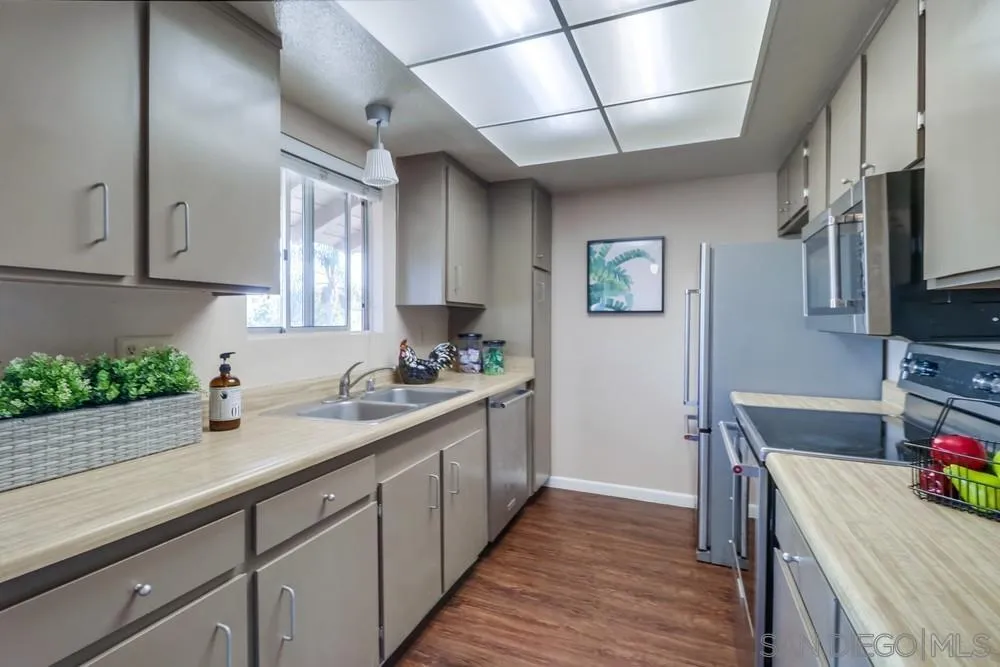 4768 35th Street, Unit 4 San Diego, CA 92116 - Photo 10 of 27 a kitchen with stainless steel appliances granite countertop a sink stove and cabinets
