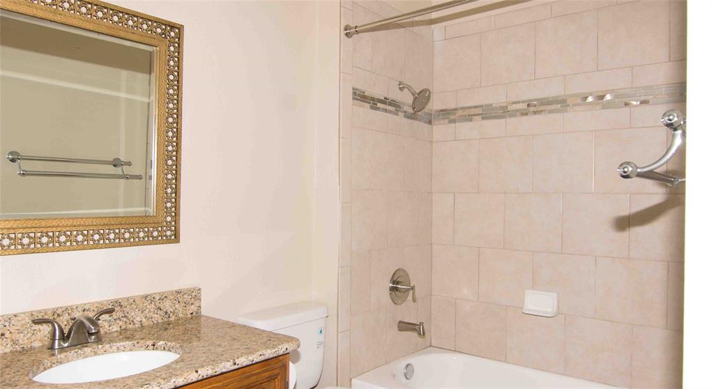 2019 West Nathan Lowe Road Arlington, TX 76017 - Photo 14 of 21 Bathroom featuring a single vanity with a granite-style countertop, undermount sink, and brushed nickel faucet
