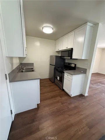 a kitchen with stainless steel appliances a stove a sink and a refrigerator