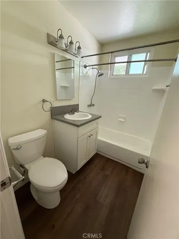 a bathroom with a sink a toilet and a shower