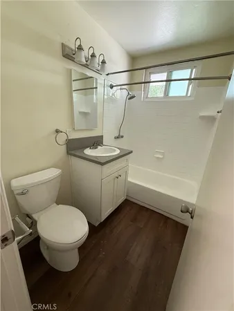 a bathroom with a sink a toilet and a shower