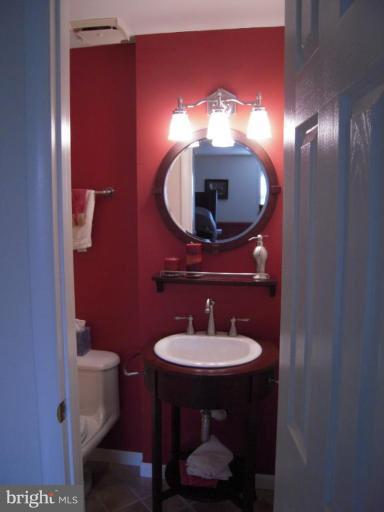 17317 Soper Street Poolesville, MD 20837 - Photo 14 of 29 a bathroom with a sink and a mirror