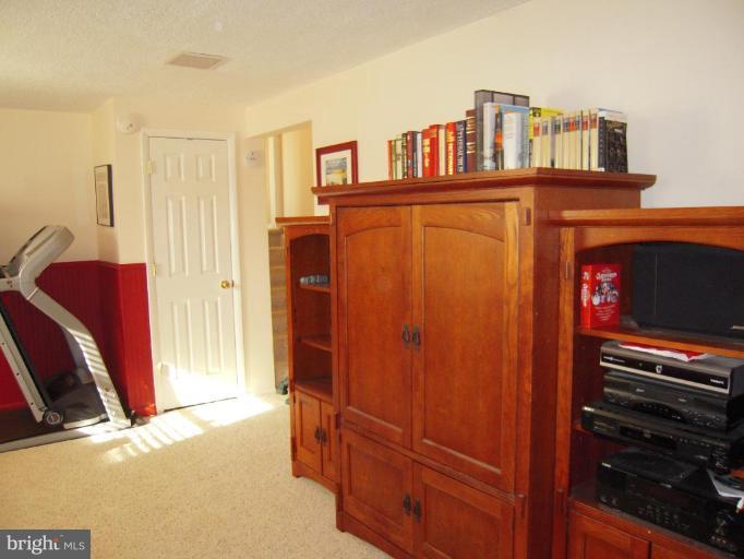 17317 Soper Street Poolesville, MD 20837 - Photo 16 of 29 a view of bedroom with furniture and a refrigerator