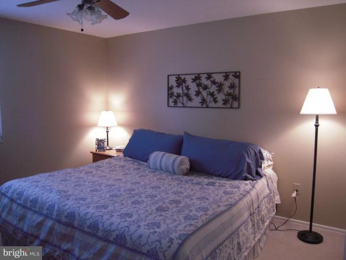 17317 Soper Street Poolesville, MD 20837 - Photo 17 of 29 a bedroom with a bed and a lamp