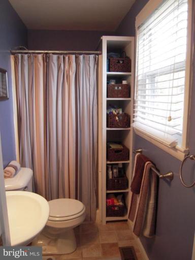 17317 Soper Street Poolesville, MD 20837 - Photo 18 of 29 a bathroom with a toilet a sink and a window