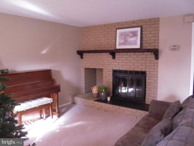 17317 Soper Street Poolesville, MD 20837 - Photo 3 of 29 a living room with furniture and a fireplace