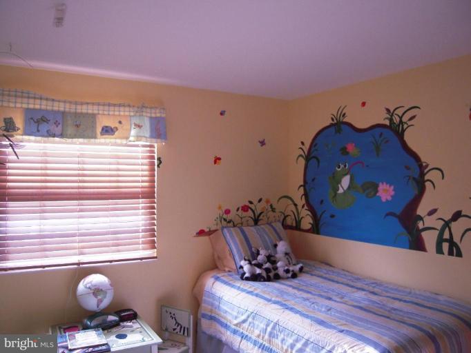 17317 Soper Street Poolesville, MD 20837 - Photo 22 of 29 a bed room with a bed and couch