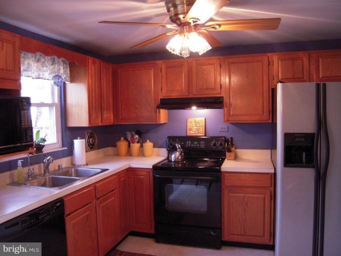 17317 Soper Street Poolesville, MD 20837 - Photo 7 of 29 a kitchen with stainless steel appliances a sink stove and refrigerator