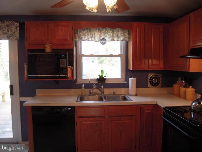 17317 Soper Street Poolesville, MD 20837 - Photo 8 of 29 a kitchen with a sink stove top oven and cabinets