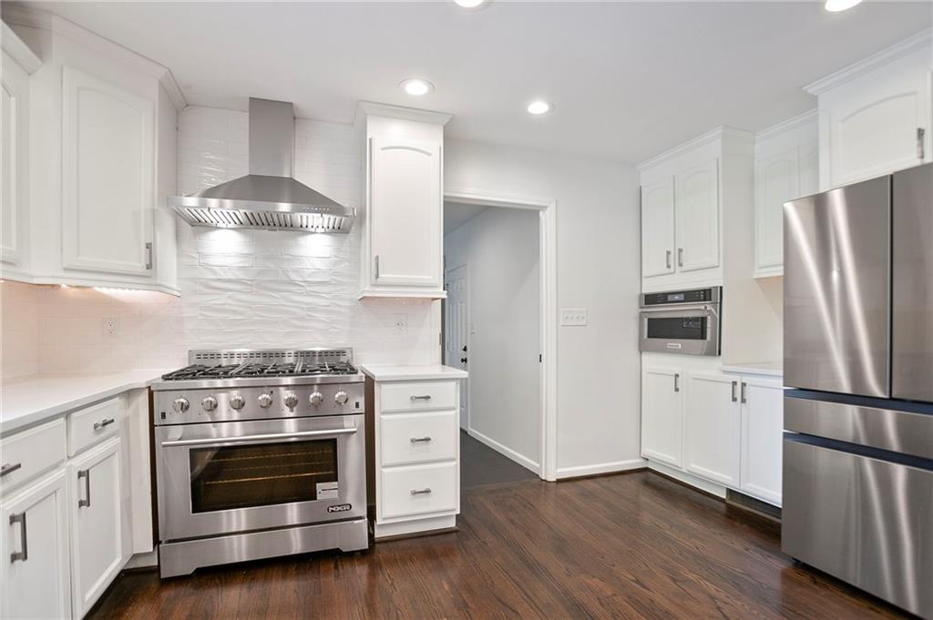 4555 Runnemede Road Northwest Atlanta, GA 30327 - Photo 12 of 51 a kitchen with a stove and a refrigerator