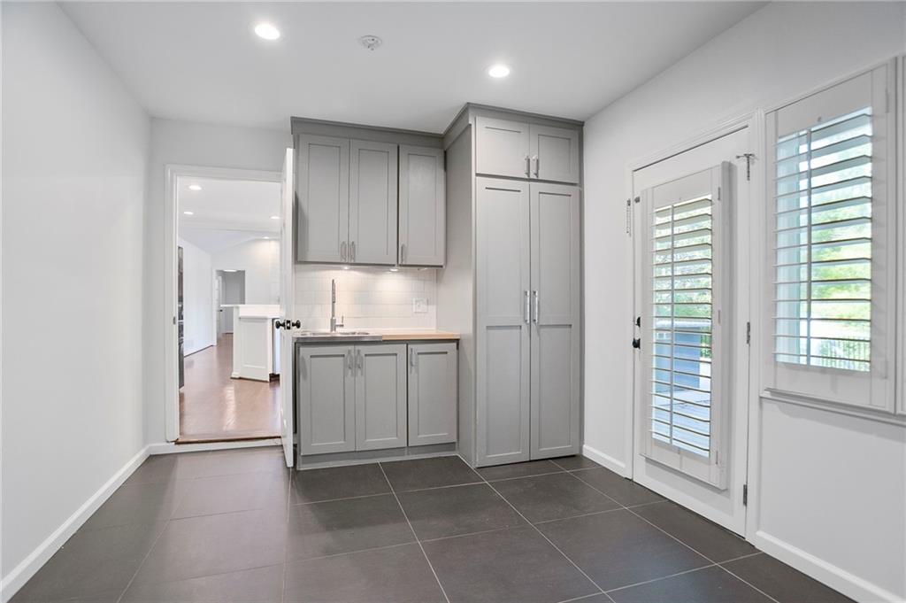 4555 Runnemede Road Northwest Atlanta, GA 30327 - Photo 14 of 51 a kitchen with a refrigerator a sink and cabinets