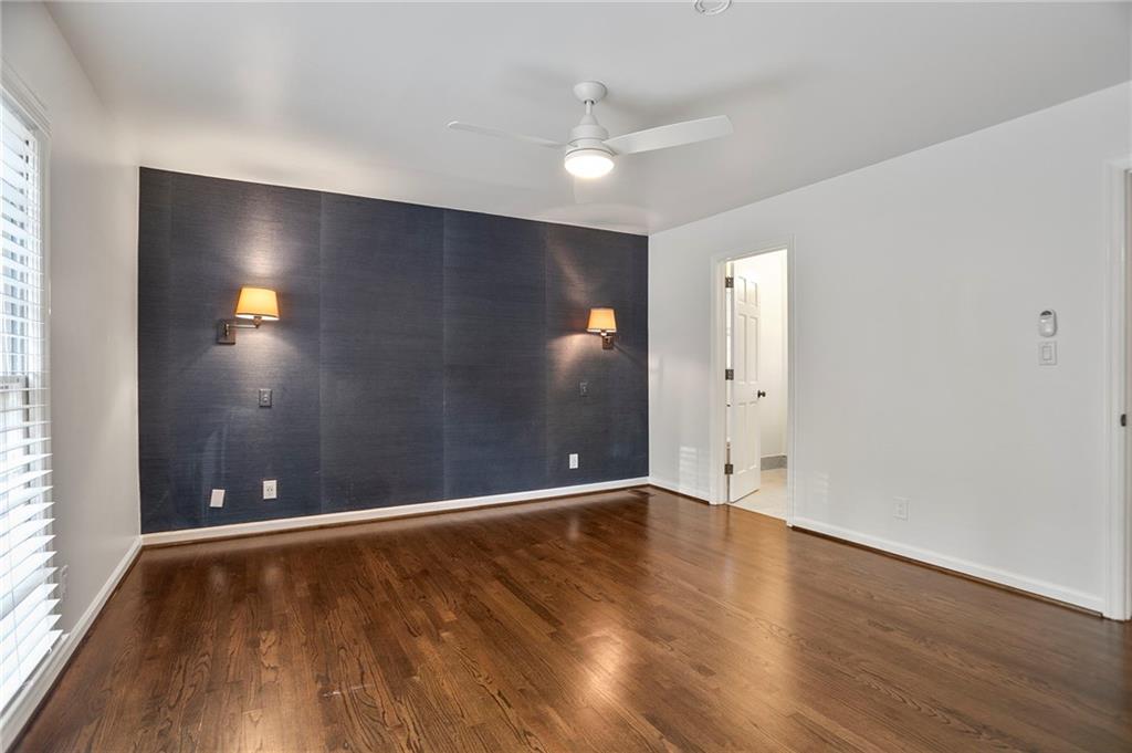 4555 Runnemede Road Northwest Atlanta, GA 30327 - Photo 21 of 51 an empty room with wooden floor and windows