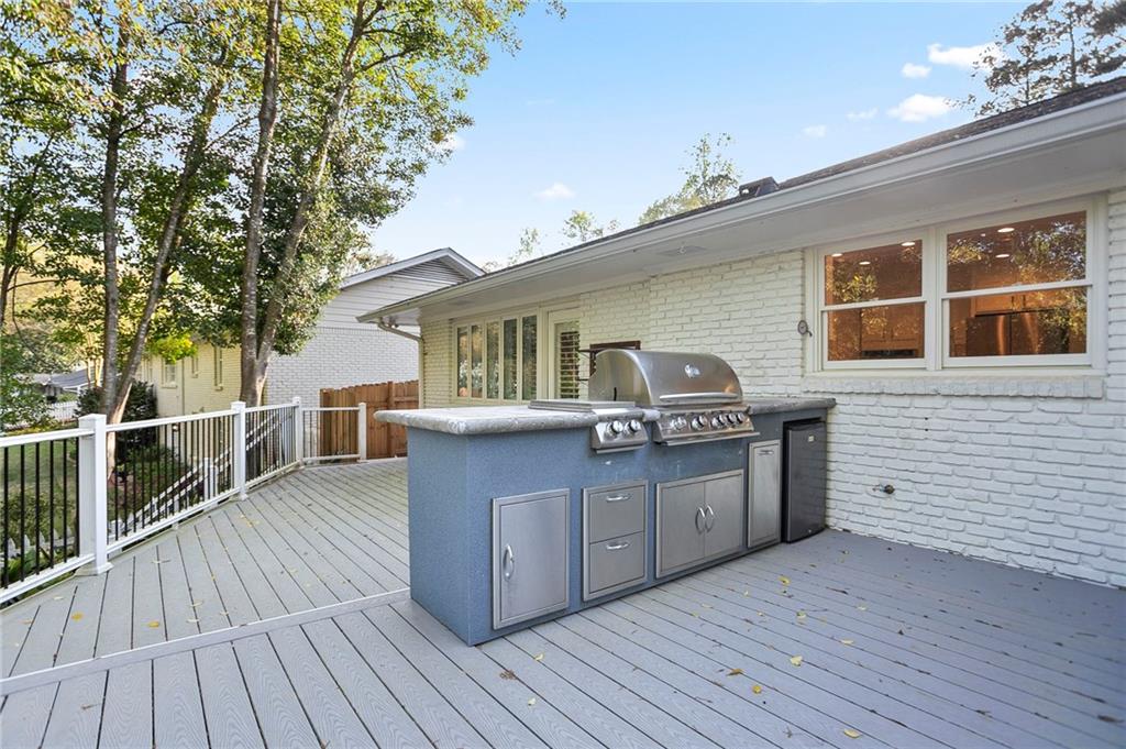 4555 Runnemede Road Northwest Atlanta, GA 30327 - Photo 35 of 51 a front view of a house with a barbeque