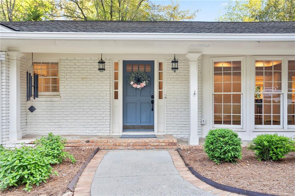4555 Runnemede Road Northwest Atlanta, GA 30327 - Photo 4 of 51 a front view of a house with garden