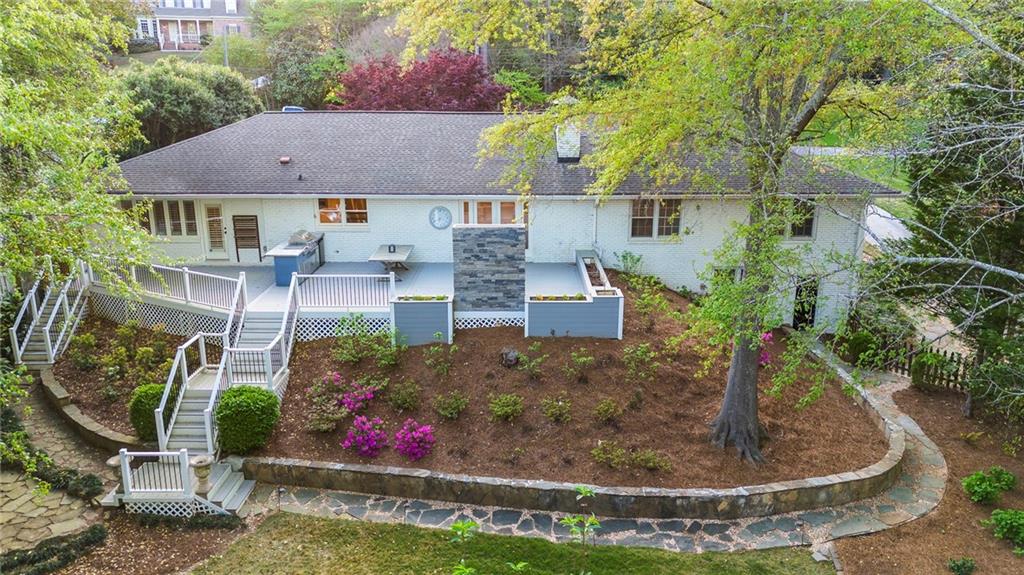 4555 Runnemede Road Northwest Atlanta, GA 30327 - Photo 49 of 51 a view of a house with a yard and sitting area