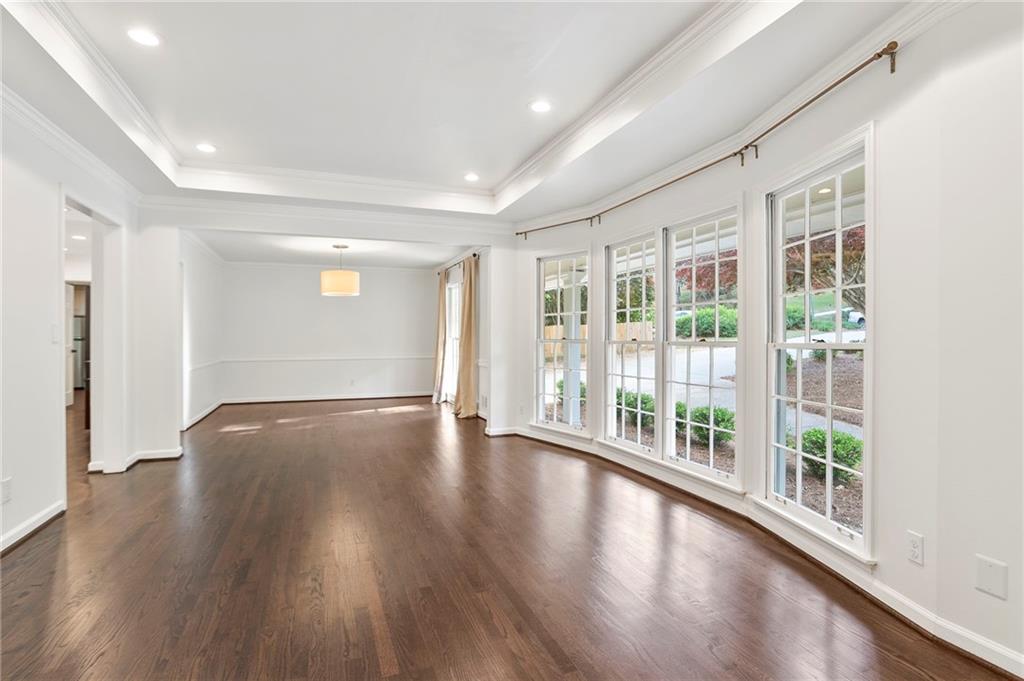 4555 Runnemede Road Northwest Atlanta, GA 30327 - Photo 5 of 51 a view of empty room with wooden floor and fan