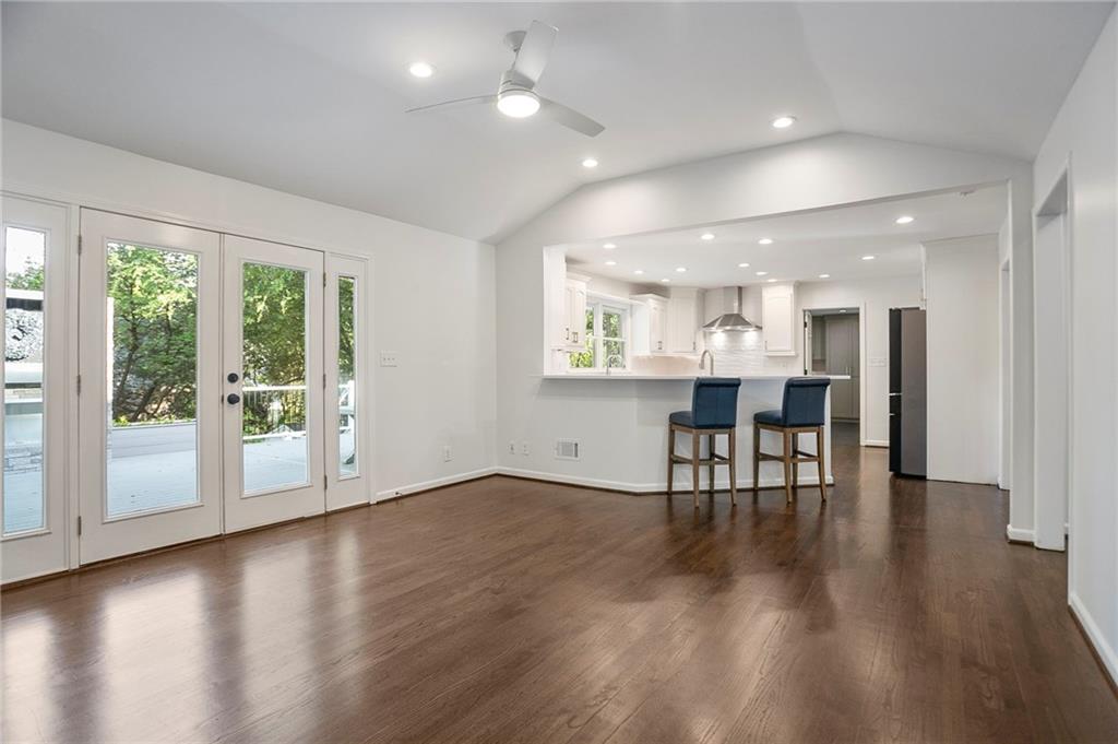 4555 Runnemede Road Northwest Atlanta, GA 30327 - Photo 9 of 51 an empty room with wooden floor and windows