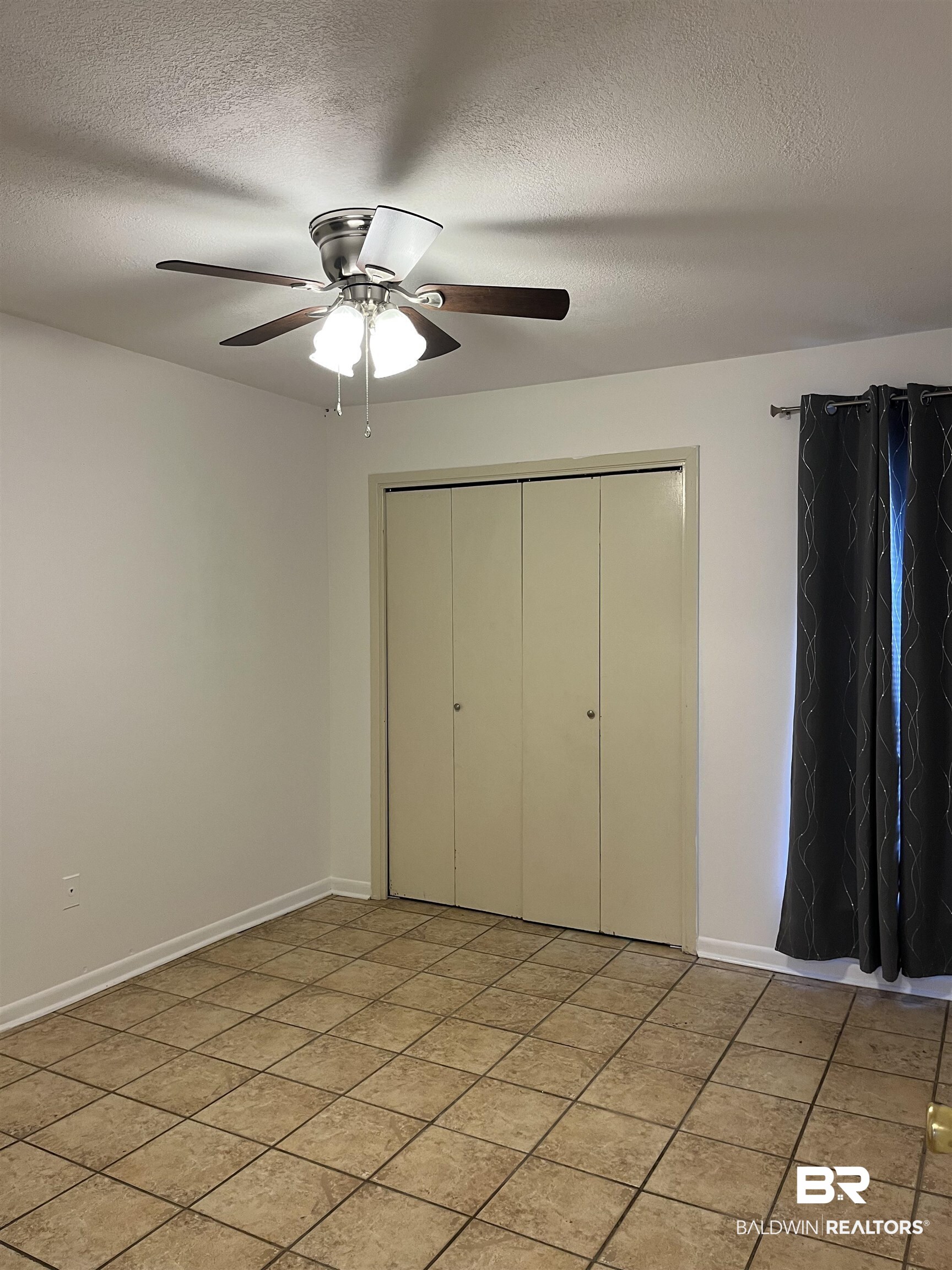1146 North Alston Street Foley, AL 36535 - Photo 16 of 20 Unfurnished bedroom with a textured ceiling, a closet, and ceiling fan