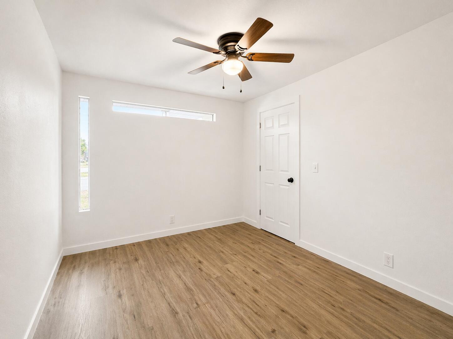 2316 48th Street Lubbock, TX 79412 - Photo 14 of 18 an empty room with wooden floor and ceiling fan
