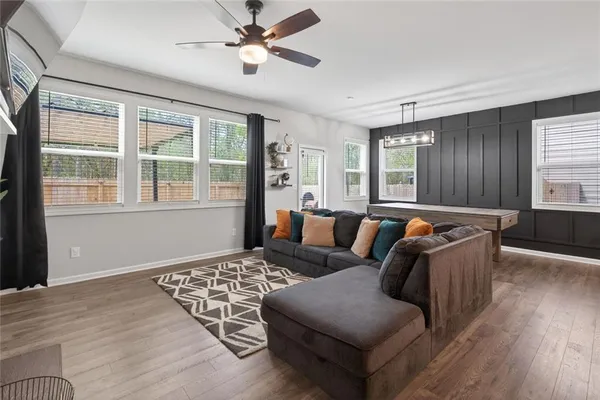 a living room with furniture and wooden floor
