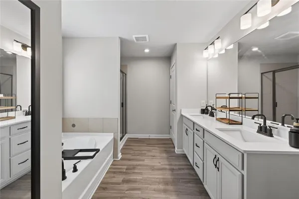 a bathroom with a double vanity sink a mirror and a shower