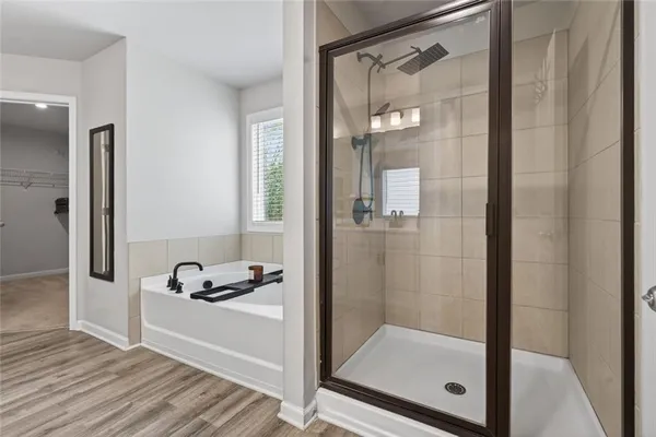 a bathroom with a tub and shower