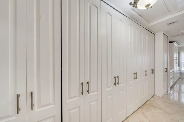 a large white kitchen with a large window