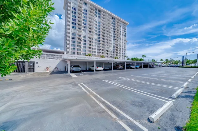 a picture of a building with a bench and potted plants