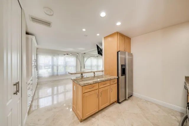 a bathroom with a granite countertop sink toilet a mirror and shower