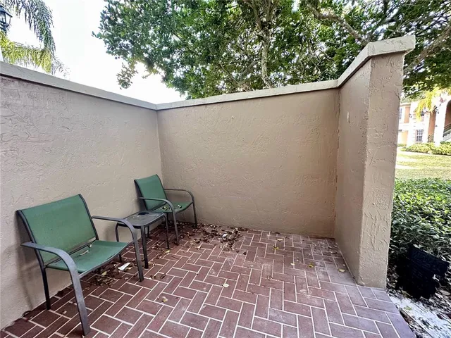 a backyard of a house with table and chairs