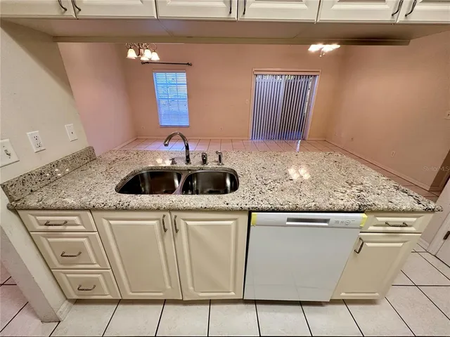 a kitchen with granite countertop cabinets and sink