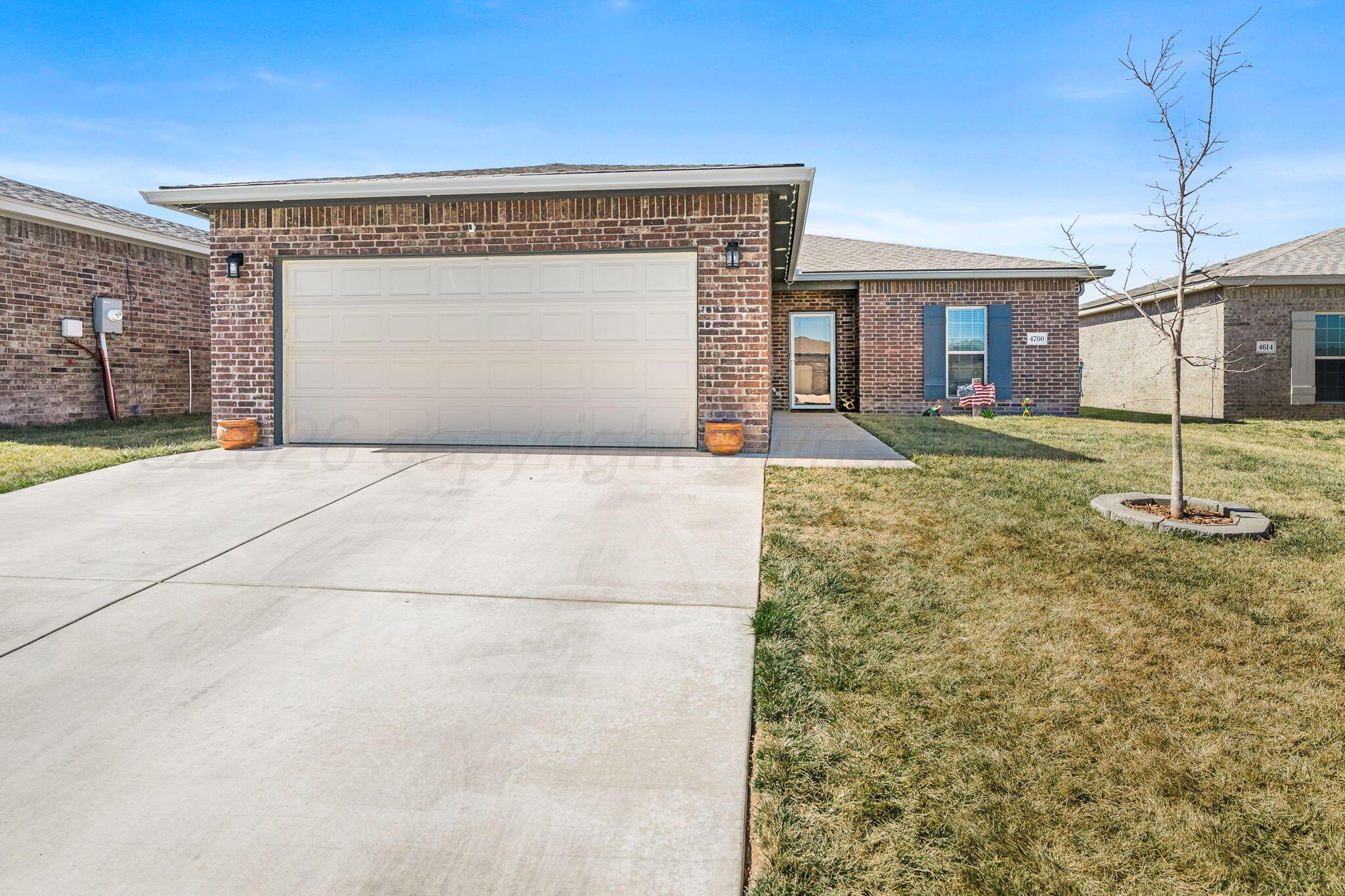 4700 Longbird Street Amarillo, TX 79118 - Photo 1 of 23 a view of a house with a garage and yard
