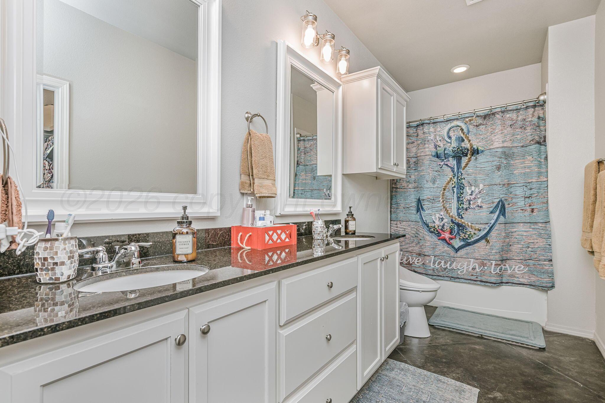 4700 Longbird Street Amarillo, TX 79118 - Photo 12 of 23 a bathroom with double vanity sink a mirror and a shower