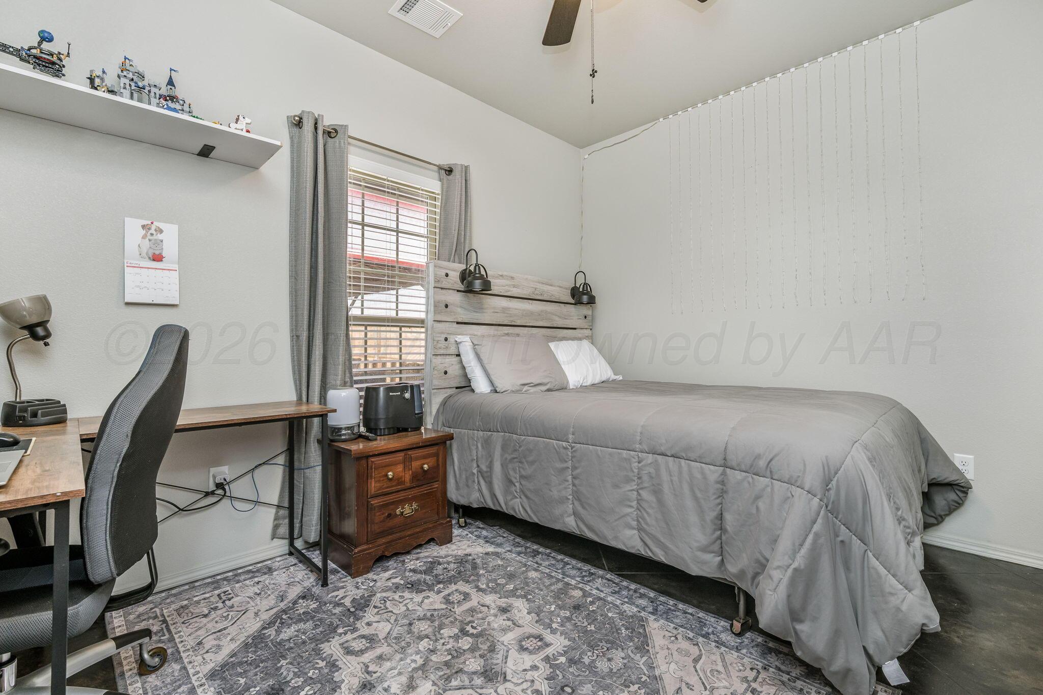 4700 Longbird Street Amarillo, TX 79118 - Photo 13 of 23 a bedroom with a bed a table and chair