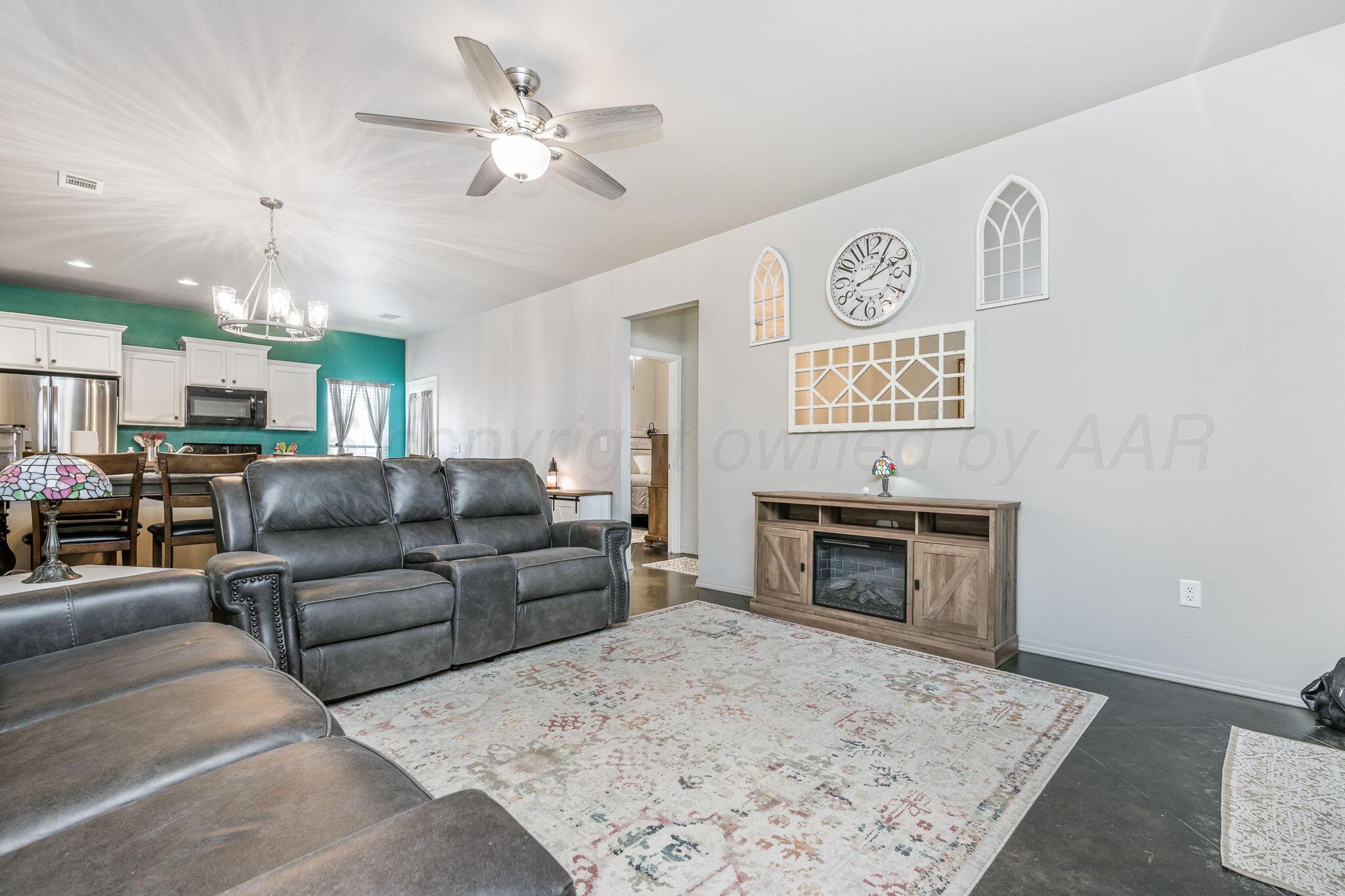 4700 Longbird Street Amarillo, TX 79118 - Photo 5 of 23 a living room with furniture fireplace and kitchen view
