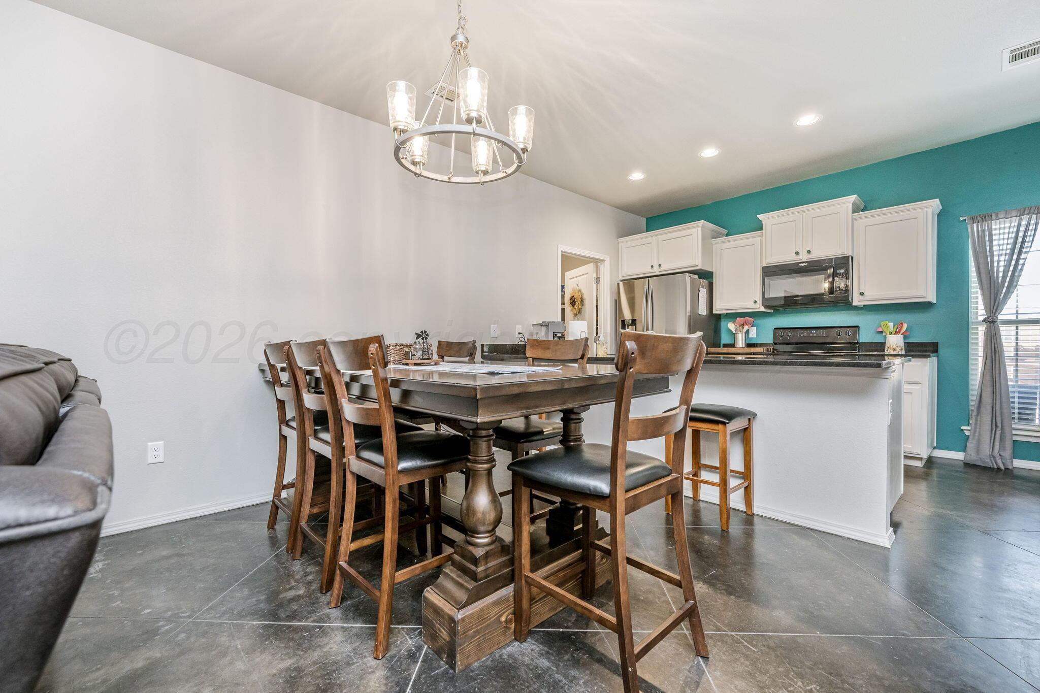 4700 Longbird Street Amarillo, TX 79118 - Photo 6 of 23 a view of a dining room with furniture and wooden floor
