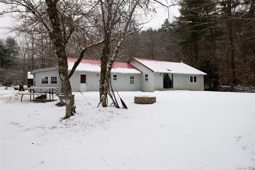 a view of house with a yard covered in snow