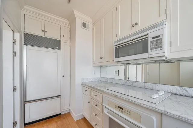 a kitchen with granite countertop cabinets stainless steel appliances and a granite counter tops